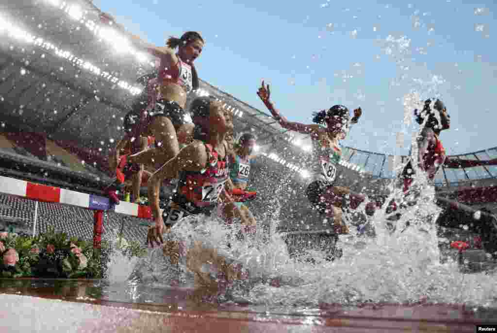 Athletes compete in the women's 3000m Steeplechase final during the 23rd Asian Athletics Championships at Khalifa International Stadium in the Qatari capital Doha