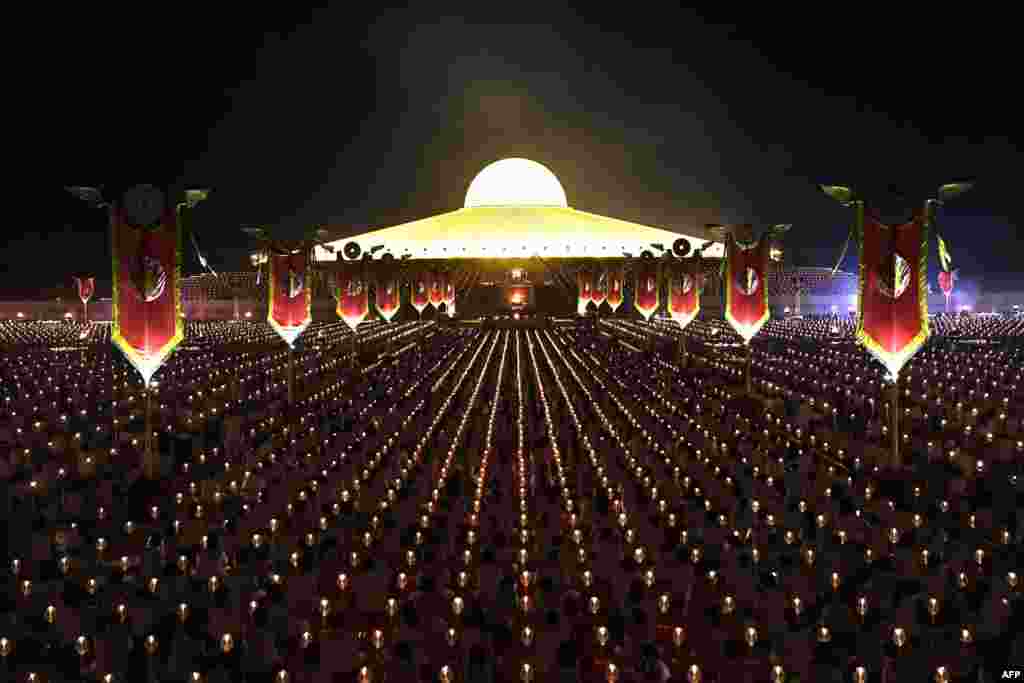 Devotees pray to mark Makha Bucha Day at the Wat Phra Dhammakaya temple, near Bangkok, Thailand, Feb. 19, 2019.