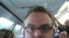 This fellow is clearly THRILLED to have been assigned a center seat.