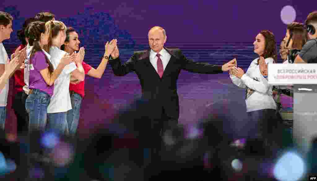Russian President Vladimir Putin arrives to give a speech at a forum of volunteers in Moscow.