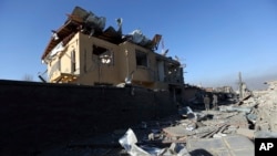 Afghan security forces investigate the aftermath of Wednesday's suicide attack and shooting in district police headquarters in Kabul, Afghanistan, March 2, 2017.
