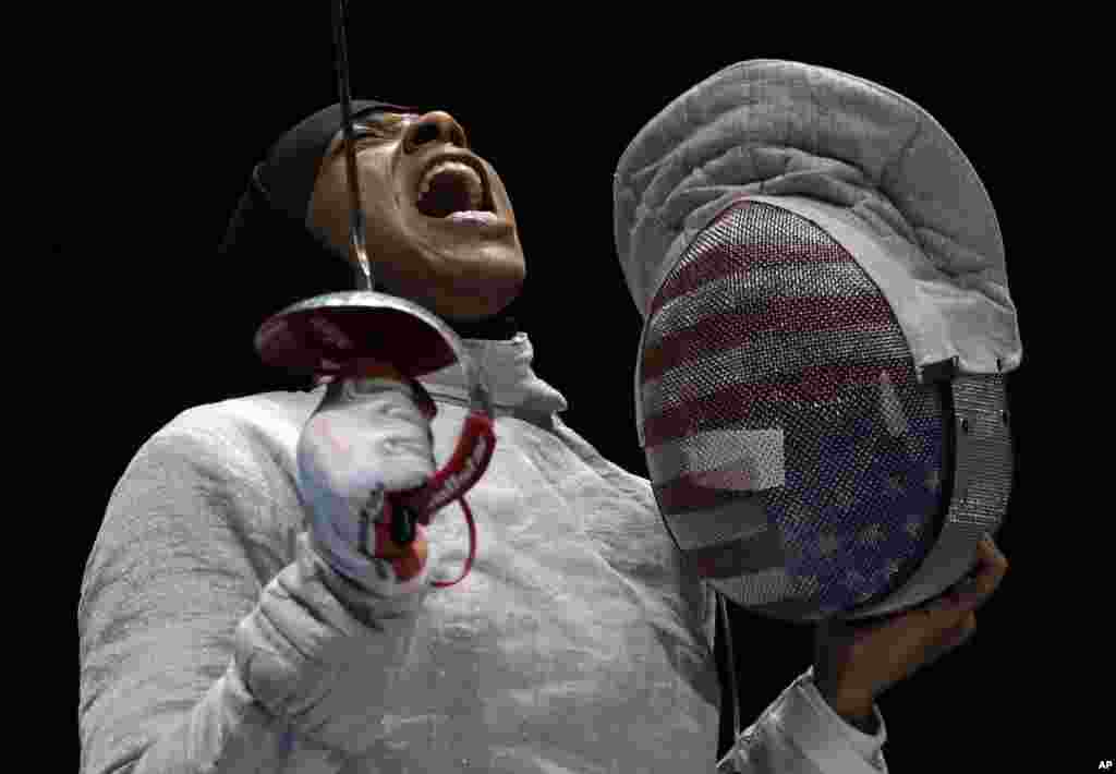 American Ibtihaj Muhammad celebrates after winning a point to Russia in a women's team sabre fencing semifinal at the 2016 Summer Olympics in Rio de Janeiro, Brazil, Aug. 13, 2016.
