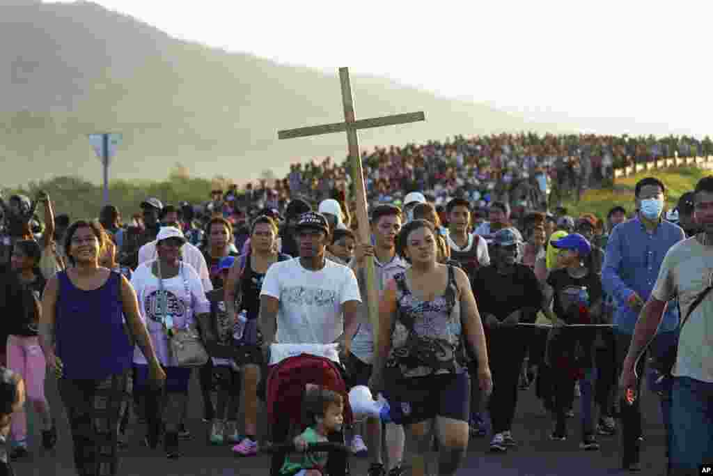 Migrants leave Huixtla, Chiapas state, Mexico, as they continue their trek north toward Mexico's northern states and the U.S. border.