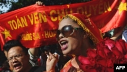 File - Bui Thi Minh Hang (R), during an anti-China protest in downtown Hanoi on July 24, 2011. 