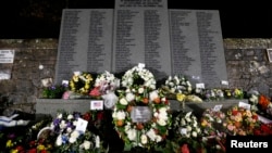 Wreaths at a memorial event on the 25th anniversary of the bombing of Pan Am flight 103, in the Dryfesdale Cemetery, Lockerbie, Scotland, Dec. 21, 2013.