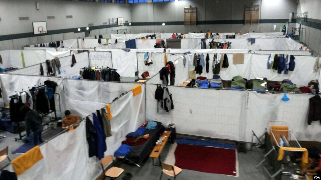 A gym is separated into cubicles where refugees sleep on cots, in a camp near Holzdorf, Germany, Nov. 29, 2015. Residents say the lack of outside interaction makes them feel isolated, and more like prisoners than asylum-seekers. (VOA News)