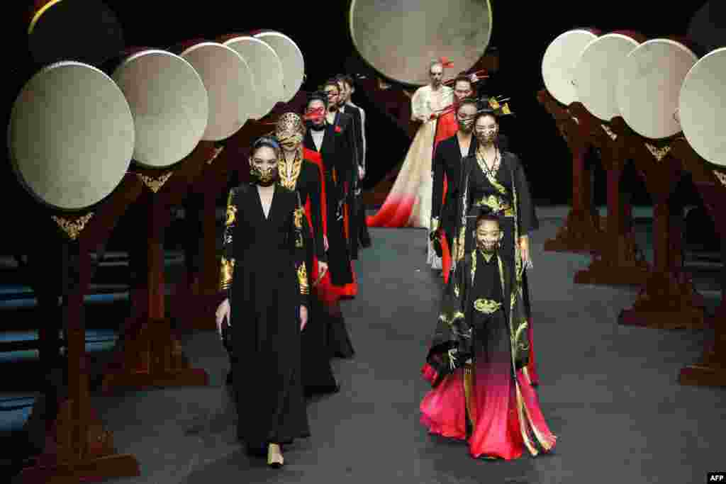 Models display creations from the "Heaven Gaia" collection by Xiong Ying during the China Fashion Week in Beijing.