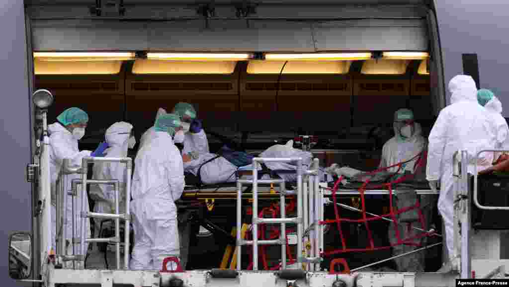 Medics wearing PPE are seen inside the Airbus A310-900 MRTT MedEvac Hermann Koehl of the German armed forces Bundeswehr as they prepare an airlift and transport of patients infected with the Covid-19 to other intensive care units (ICU) in the country, at Dresden International Airport, Saxony, eastern Germany.