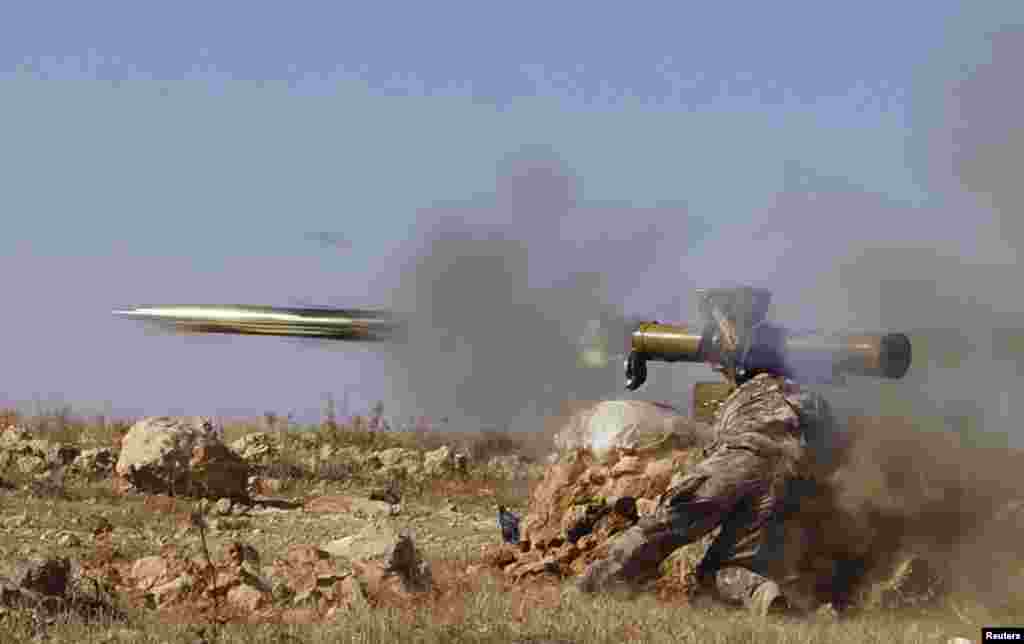 A Free Syrian Army fighter fires an anti-tank missile towards what the FSA said were locations controlled by forces loyal to Syria's President Bashar al-Assad in the eastern Hama countryside, Oct. 17, 2013.