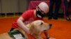 Children's Hospital patient Draegan Crabb, age nine, pets a therapy dog following an announcement that The Children's Hospital at OU Medicine will be getting another therapy dog to add to their team, July 22, 2019, in Oklahoma City.
