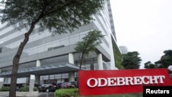 Federal police cars are parked in front of the headquarters of Odebrecht, a large private Brazilian construction firm, in Sao Paulo, Brazil, June 19, 2015.