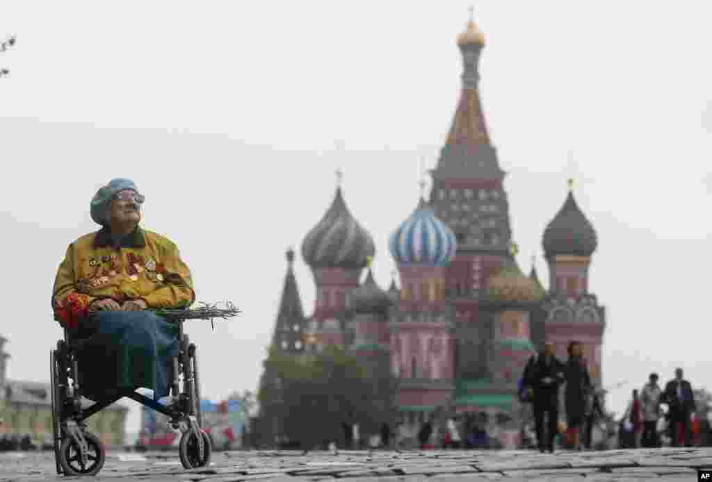 A veteran sits in a wheelchair in front of St. Basil's Cathedral after the Victory Day parade marking the 74th anniversary of the Allied victory over Nazi Germany in World War II, in Red Square in Moscow, Russia.