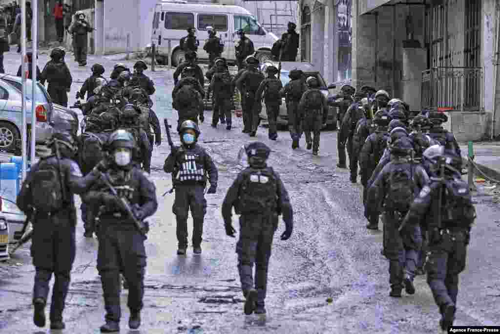 Israeli security forces secure the area around the family home of Palestinian Hamas member Fadi Abu Shkhaydam who was killed by Israeli police last year, ahead of its demolition in the Shufat refugee camp in Jerusalem.