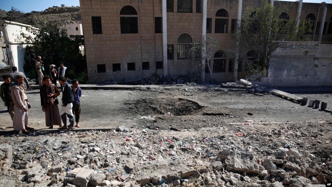 FILE - Shiite fighters, known as Houthis, gather at the site of a Saudi-led coalition airstrike in Sanaa, Yemen, Friday, Oct. 16, 2015. 