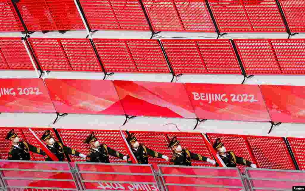 Paramilitary police officers march in a line at the alpine skiing victory ceremony during the 2022 Beijing Olympics, at the National Alpine Skiing Centre, Yanqing district, Beijing, China.