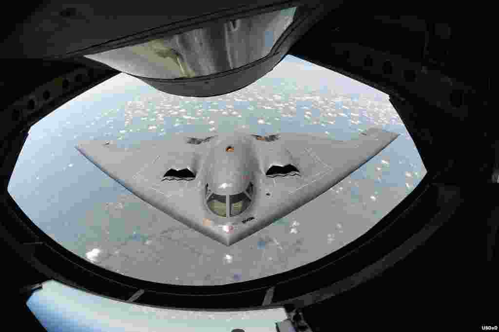 A U.S. Air Force B-2 Spirit bomber aircraft approaches the rear of a KC-135 Stratotanker aircraft before refueling during a training mission over the Midwest. The B-2's unique design enables it to travel into enemy territory to deploy ordnance without being detected by radar. (DoD photo by Airman 1st Class John Linzmeier, U.S. Air Force/Released on Aug.7, 2013)