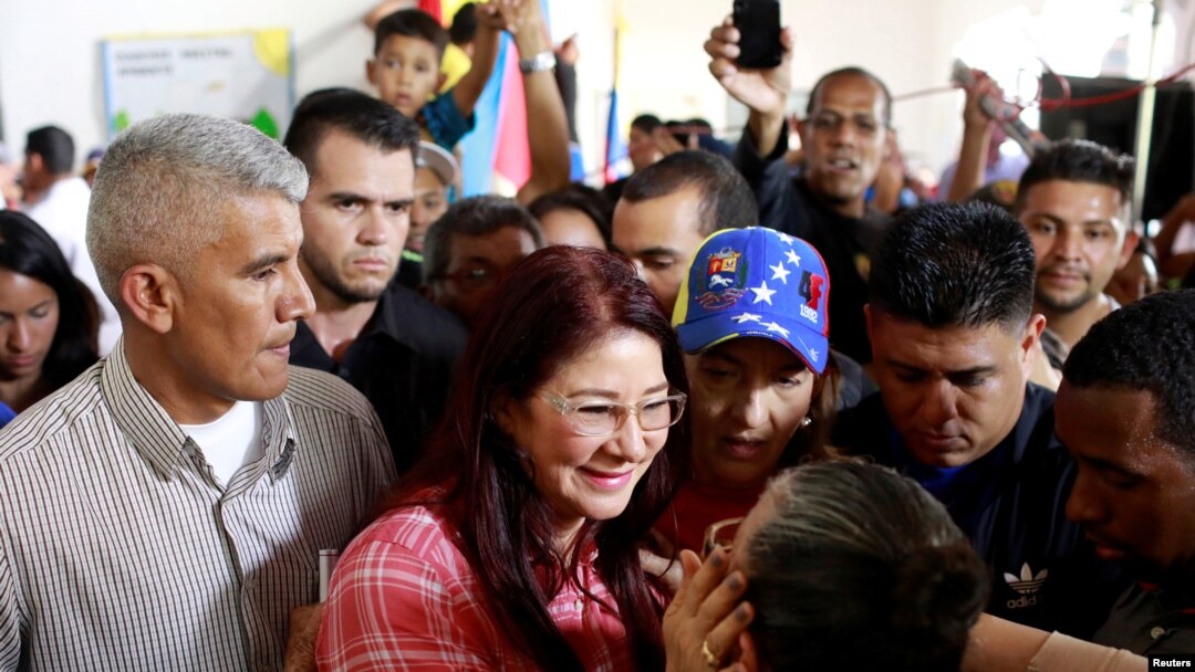 Cilia Flores (red shirt), wife of Venezuela's President Nicolas Maduro, greets supporters as she arrives for a simulation of the government's official July 30 vote for a new assembly, in Caracas, Venezuela July 16, 2017. 