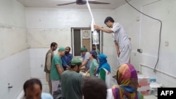 In this photograph released by Medecins Sans Frontieres (MSF) on October 3, 2015, Afghan MSF surgeons work in an undamaged part of the MSF hospital in Kunduz after the operating theaters were destroyed in an airstrike. 