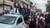 Pessoas saem para as ruas de Porto Sudão para celebrar o avanço das forças militares sudanesas e dos grupos armados aliados sobre a capital do estado de Al-Jazira, Wad Madani, detida pelas Forças de Apoio Rápido (RSF) paramilitares, a 11 de janeiro de 2025.
