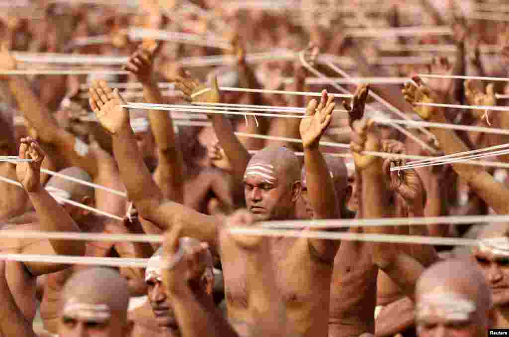 Newly initiated Naga Sadhus or Hindu holy men of the Juna Akhara attend the Dikasha ritual on the banks of the river Ganges during the ongoing "Kumbh Mela", or the Pitcher Festival, in Prayagraj, previously known as Allahabad, India.