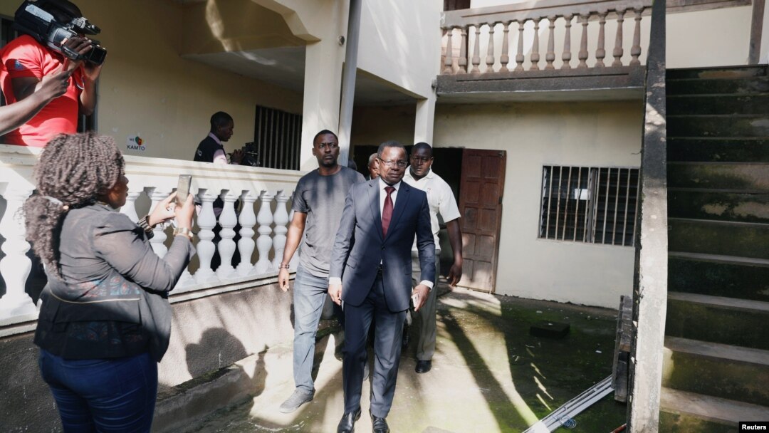 FILE - Maurice Kamto, leader of the Cameroon Renaissance Movement, walks out after a news conference in Yaounde, Cameroon, Oct. 8, 2018. A U.N. report accuses the Cameroon government of stifling him and his movement.