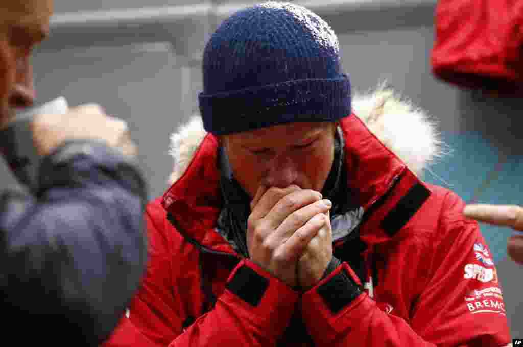 Britain's Prince Harry warms his hands after a cold chamber training exercise with the Walking with the Wounded South Pole Allied Challenge 2013 British team at Nuneaton, central England. Prince Harry joined the team inside the whole-vehicle environmental test chambers which simulate the extreme conditions they will face in the South Pole.