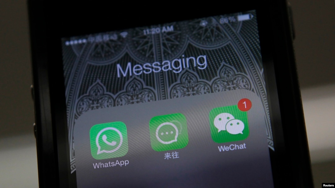FILE - Icons of messaging applications are seen on the screen of a smart phone on this photo illustration taken in Beijing, February 24, 2014. 
