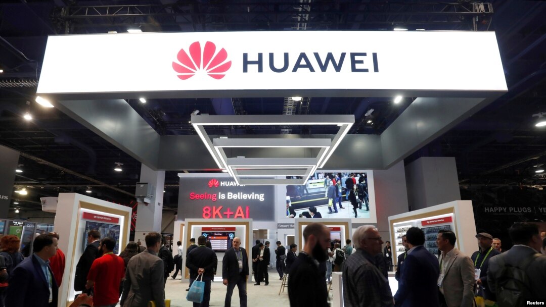 FILE - Attendees pass by a Huawei booth during the 2019 CES in Las Vegas, Nevada, Jan. 9, 2019. 