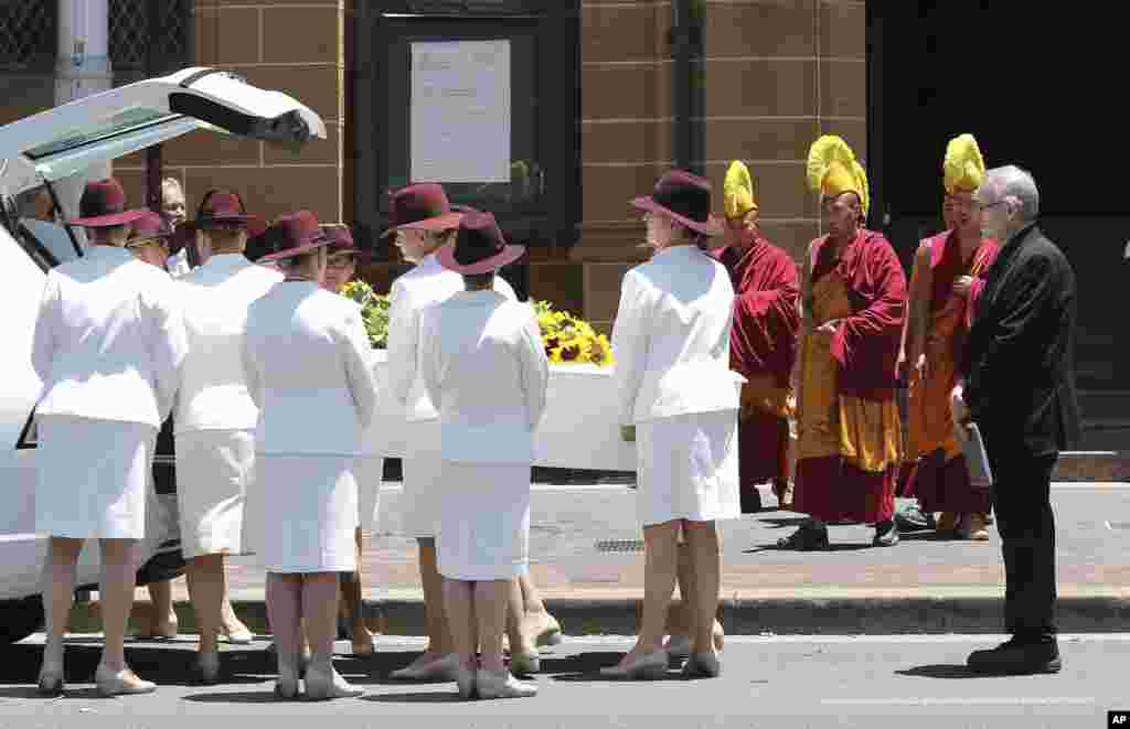 Pallbearers move the coffin of Tori Johnson into a hearse during the funeral service in Sydney, Australia, Dec. 23, 2014. 