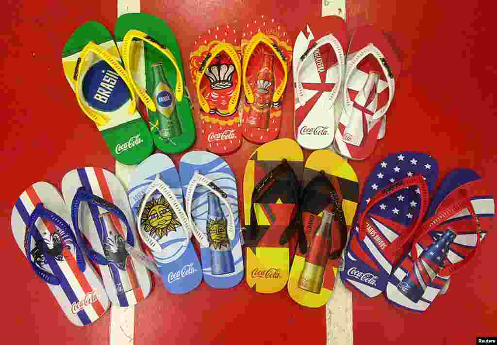 Flip-flops printed with the national flags of soccer teams are sold in a sports shop, in Rio de Janeiro, June 10, 2014.