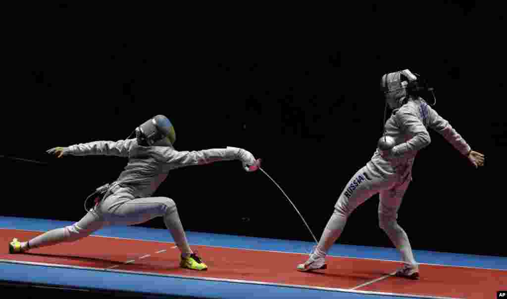 Yana Egorian of Ukraine, left, and Olena Kravatska of Russia compete in a women's team sabre fencing final at the 2016 Summer Olympics in Rio de Janeiro, Brazil, Aug. 13, 2016.