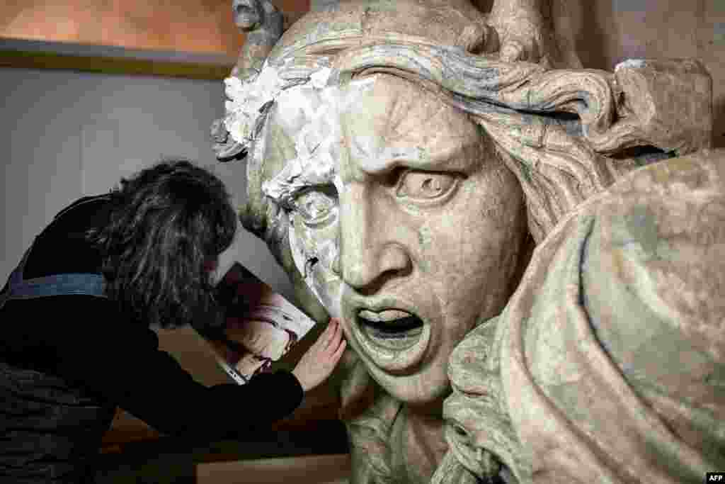 A mold of 'the Genie de la Patrie' damaged during yellow vest protests at the Arc de Triomphe last December is seen during its renovation by French restorer Agnes Le Boudec, on March 25, 2019, in Paris.
