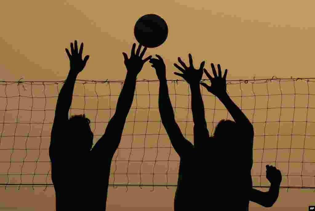 Local boys play volleyball in the Chamkar Mean village outside Phnom Penh, Cambodia, Feb. 8, 2022.