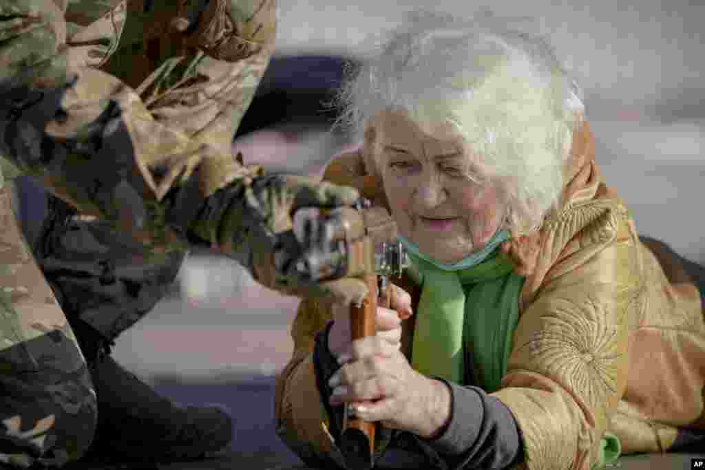 Valentyna Konstantynovska, 79, holds a weapon during basic combat training for civilians, organized by the Special Forces Unit Azov, of Ukraine's National Guard, in Mariupol, Donetsk region, eastern Ukraine.