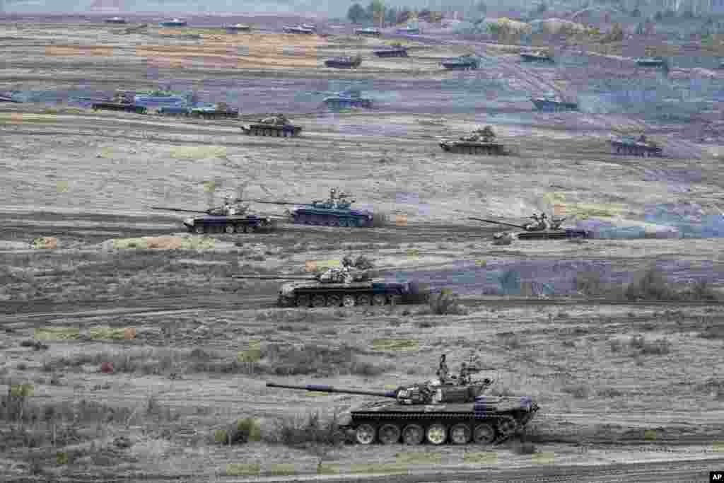 Tanks move during the Union Courage-2022 Russia-Belarus military drills at the Obuz-Lesnovsky training ground in Belarus, Feb. 19, 2022. Russia has deployed troops to its ally Belarus for sweeping joint military drills that run through Sunday, fueling Western concerns that Moscow could use the exercise to attack Ukraine from the north.