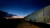 FILE - A man walks by the fence at the Pournara migrant reception center in Kokkinotrimithia outside of capital Nicosia, Cyprus, Jan. 24, 2024. 