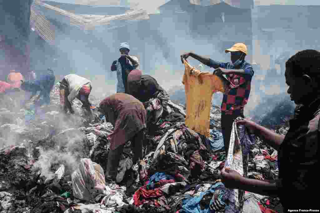 Traders scavenge clothes from debris burnt down by the fire in the early morning at Gikomba market, East Africa's largest second hand clothing market, in Nairobi, Kenya.