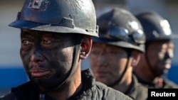 Miners wait in lines to shower during a break near a coal mine in Heshun county, Shanxi province, Dec. 5, 2014.