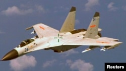 FILE - A U.S. military official says two Chinese J-11 fighters, like one pictured here, flew out to intercept a U.S. EP-3 Aries aircraft, coming so close that they forced the pilot to descend a couple hundred feet.