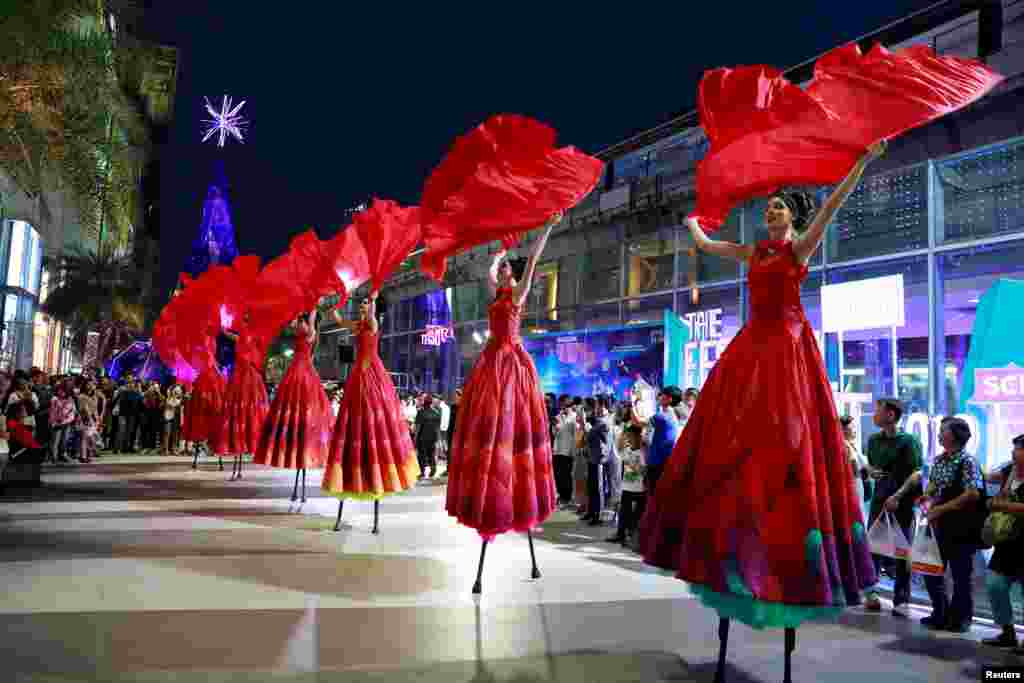 Artists perform at a shopping center during the New Year festival in Bangkok, Thailand.