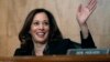 FILE - Sen. Kamala Harris, D-Calif., waves to another member of the committee during a hearing on Capitol Hil in Washington, Oct. 3, 2018. 