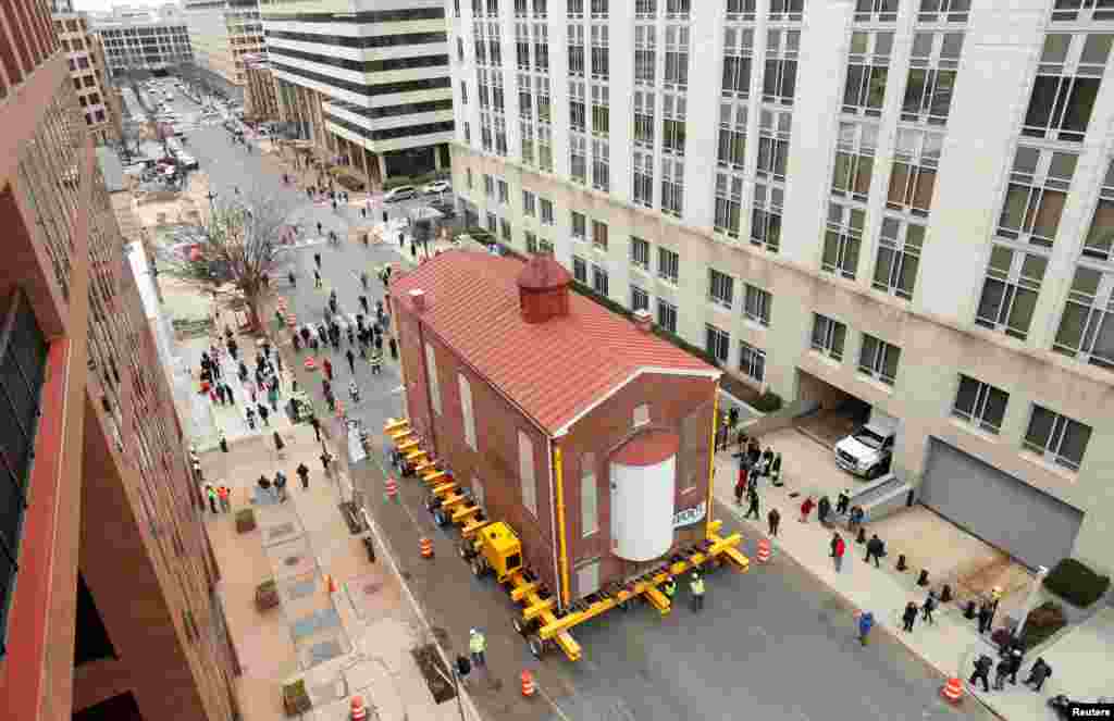 Washington's first and oldest synagogue, Adas Israel Synagogue, is moved on a remote controlled platform to its new location where it will become be the cornerstone of the Capital Jewish Museum on 3rd St. NW in Washington, D.C.