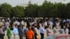 Egyptian nationals living in Kuwait stand in line at the entrance of the Egyptian Embassy before voting in Egypt's presidential elections, in Bnaid al-Gar, Kuwait, May 16, 2012.