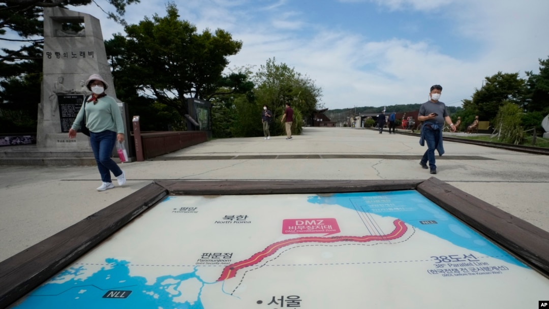 Visitors walk by a map of two Koreas showing North Korea's capital Pyongyang and South Korea's capital Seoul at the Imjingak Pavilion in Paju, near the border with North Korea, South Korea, Sept. 24, 2021.