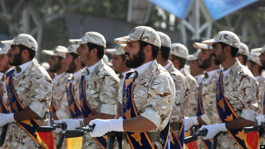 FILE - In this Sept. 22, 2011 photo, members of Iran's Revolutionary Guard march in front of the mausoleum of the late Iranian revolutionary founder Ayatollah Khomeini, just outside Tehran.