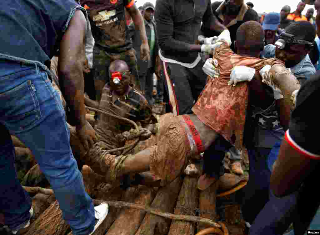 A rescued artisanal miner is carried from a pit as retrieval efforts proceed for trapped illegal gold miners in Kadoma, Zimbabwe, Feb. 16, 2019.