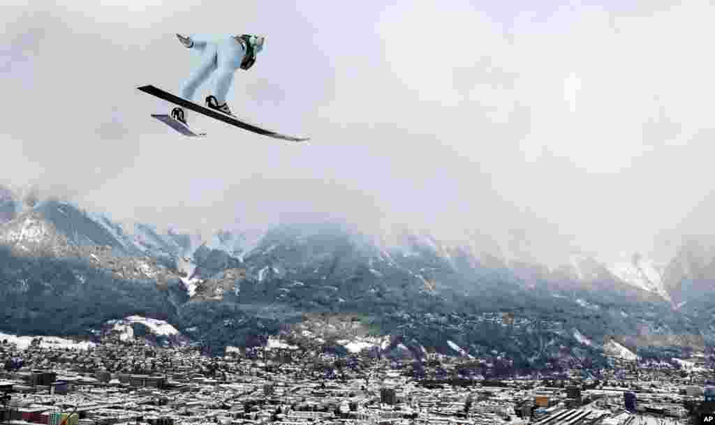 Austria's Markus Schiffner soars through the air during a trial jump at the third stage of the 67th four hills ski jumping tournament in Innsbruck, Austria.