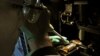 FILE - A researcher injects DNA material onto a laboratory dish.