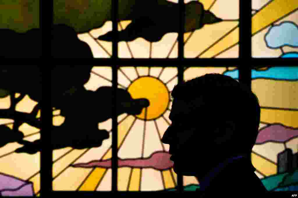 French President Emmanuel Macron is silhouetted against a window as he participates in the 'Great National Debate' with local mayors, at the prefect's residence in Bordeaux, France.