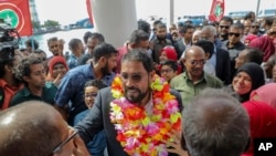 FILE - Maldives opposition leader Qasim Ibrahim, center, is welcomed at the airport as he returned home from exile in Male, Maldives, Thursday, Oct. 4, 2018.
